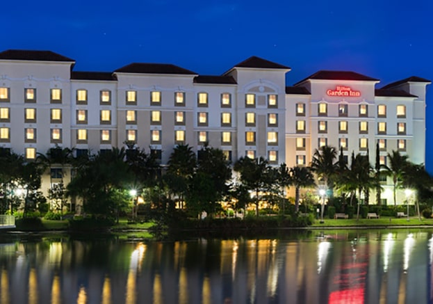 NIghtime exterior of Hilton Garden Inn Palm Beach Gardens, a Kolter Group Property