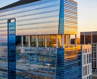 Glass high-rise hotel tower reflecting sunset light in downtown Orlando.